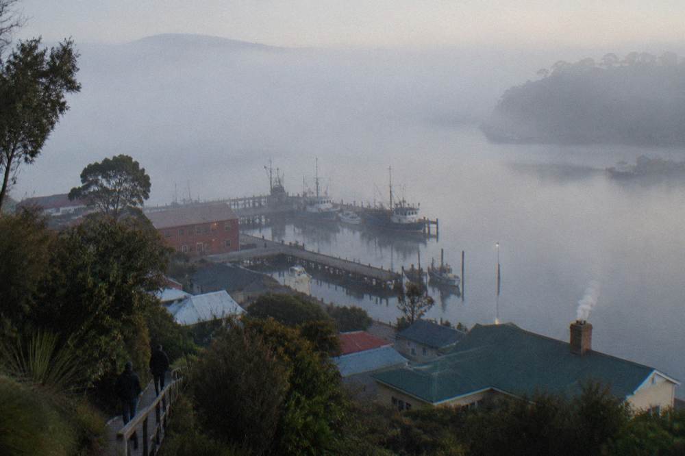 Morning mist over Macquarie Harbour with the Strahan wharf in the distance