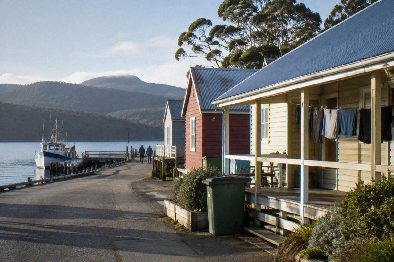 Strahan waterfront buildings along the Esplanade on Macquarie Harbour in morning light
