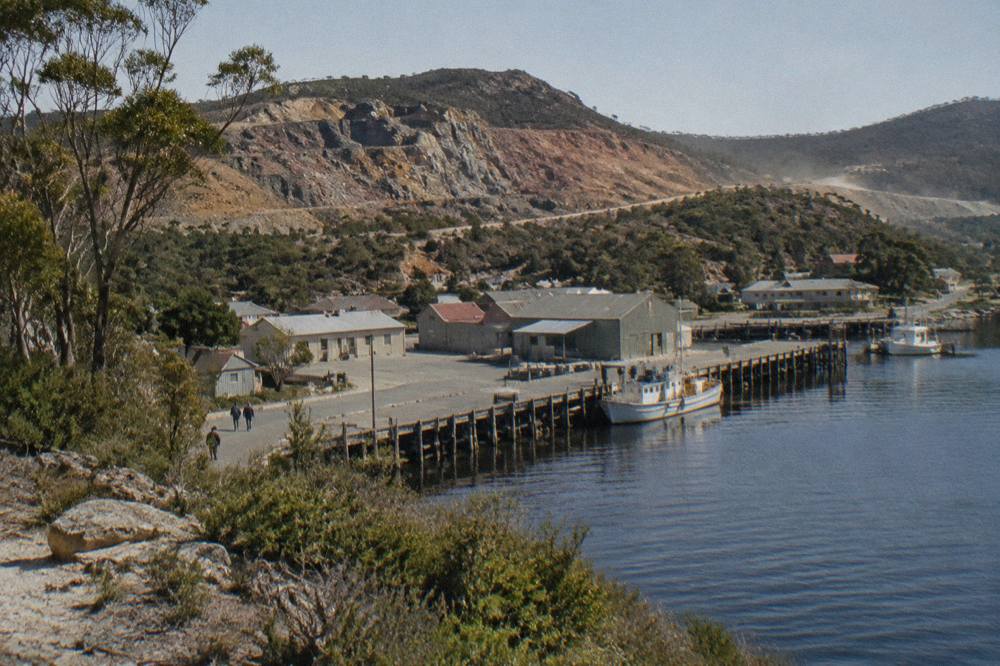 Bare rocky hillsides above a small west coast mining town