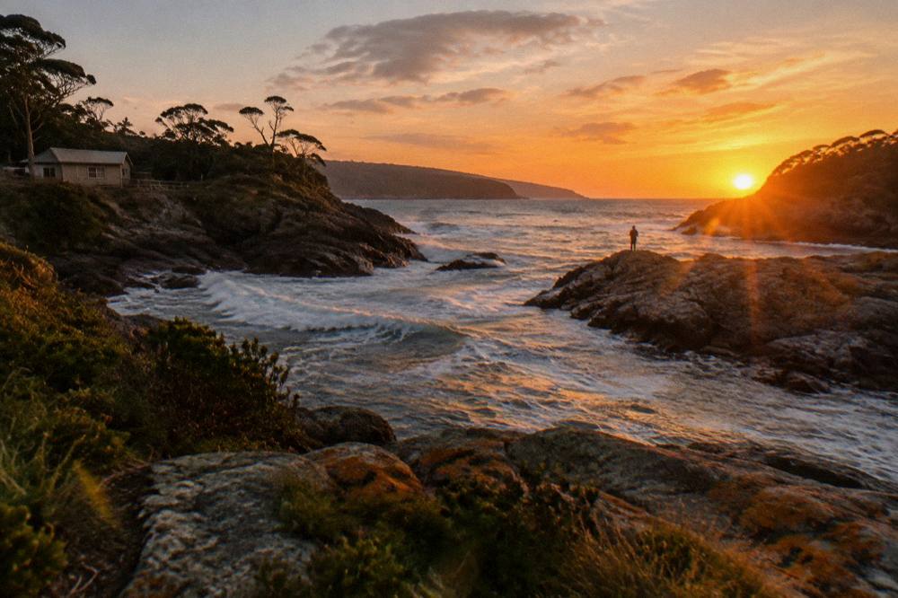 The sun setting over the water near the narrow Hells Gates entrance to Macquarie Harbour