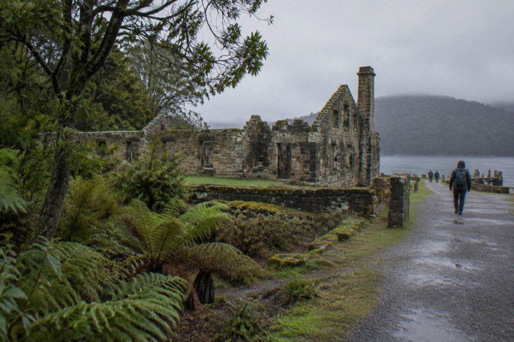 Weathered stone ruins of a convict-era settlement on a small forested island